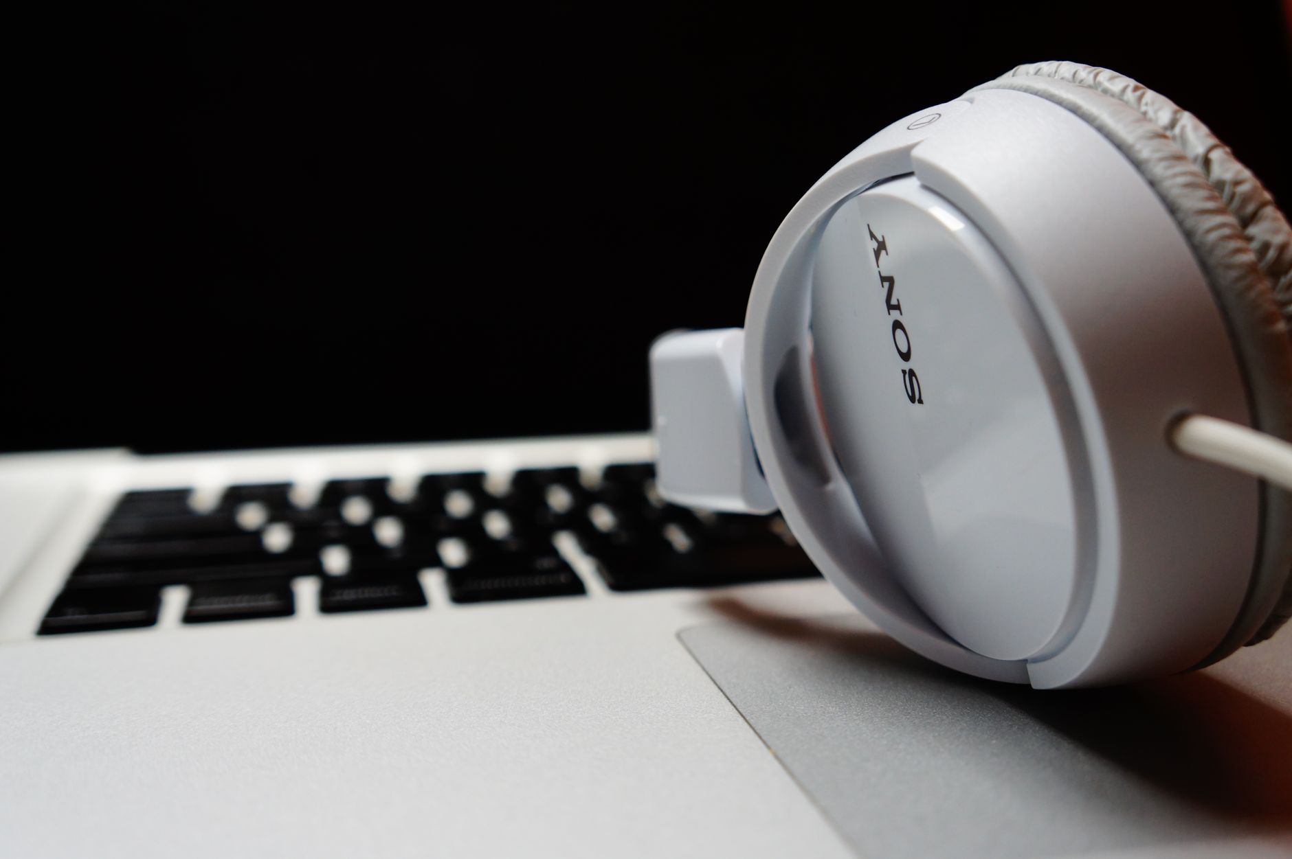 Headphones resting on a laptop keyboard