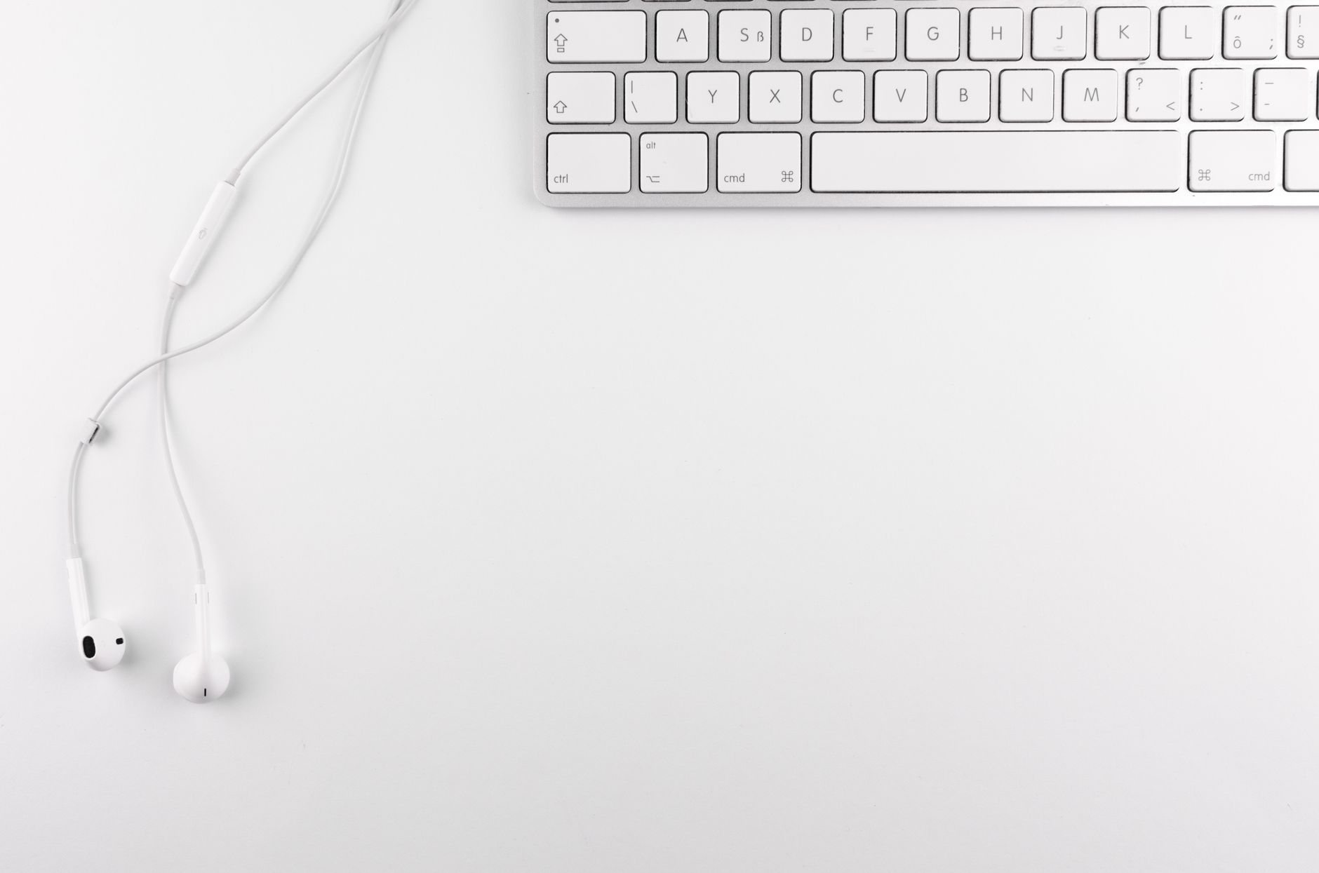 Headphones and a keyboard on a desk