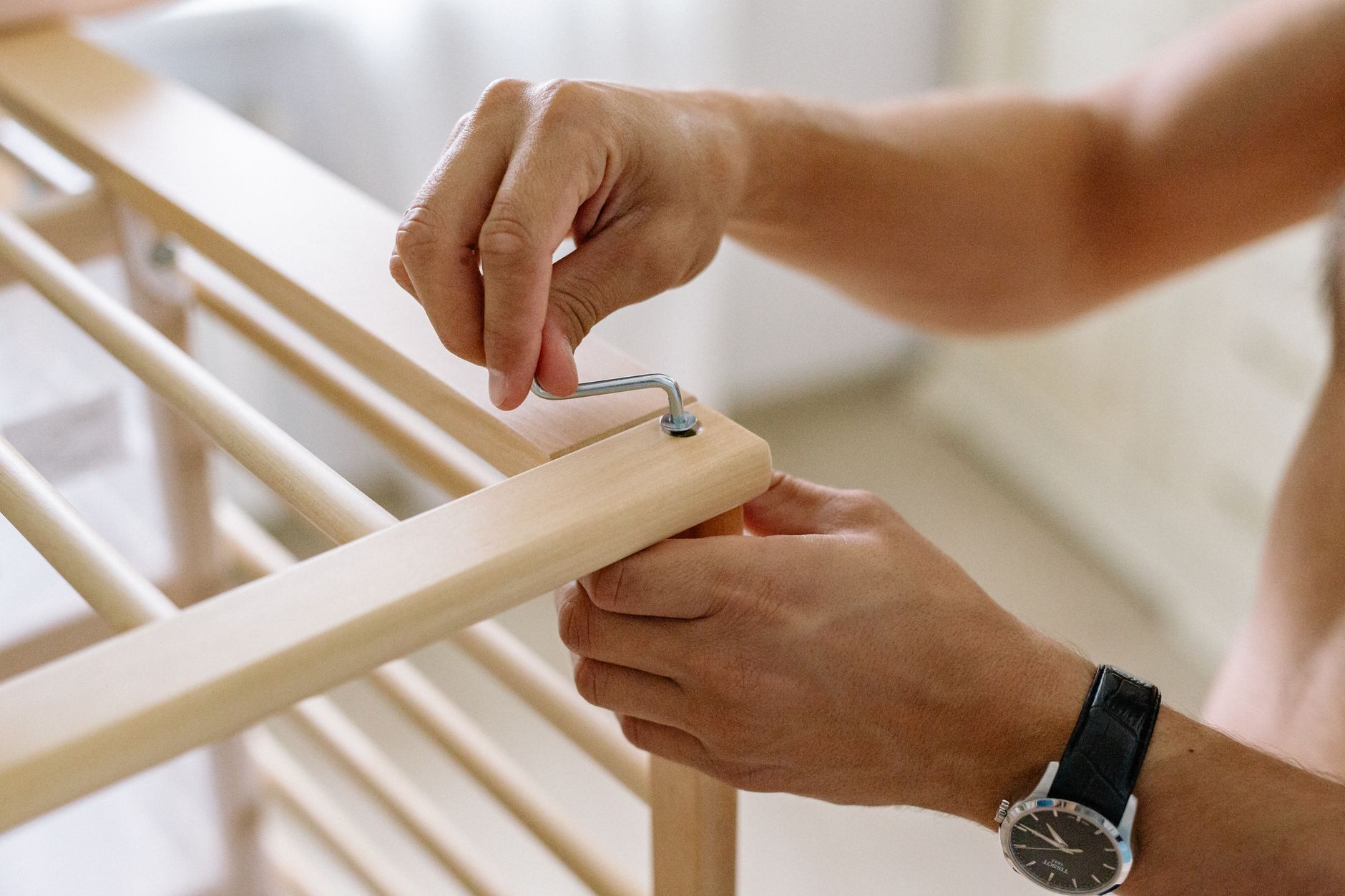 A handyman assembling furniture