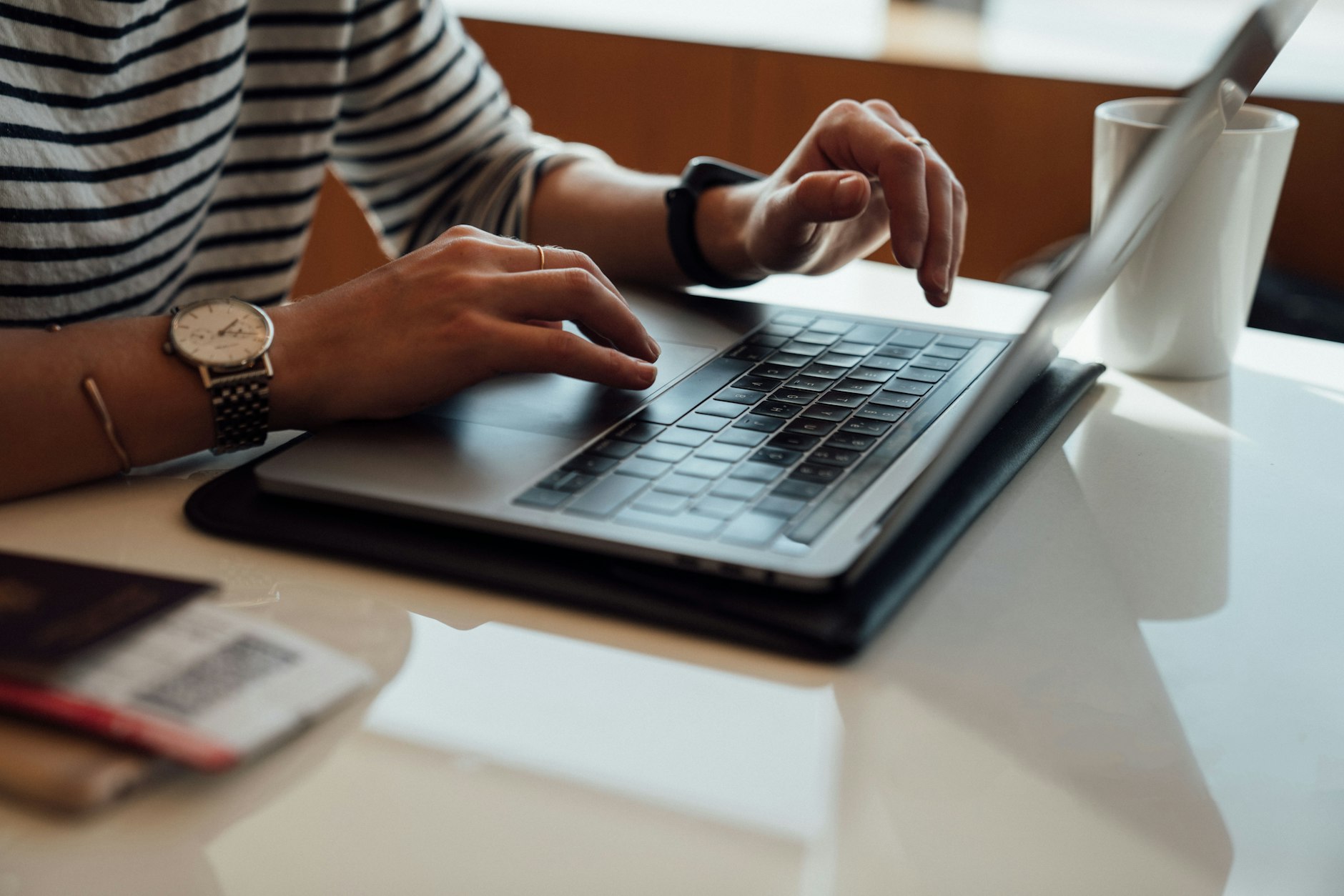 Close-up of hands typing on a laptop keyboard