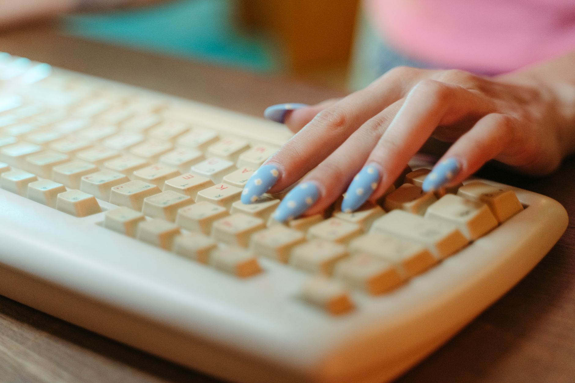 A close-up of hands typing on a keyboard