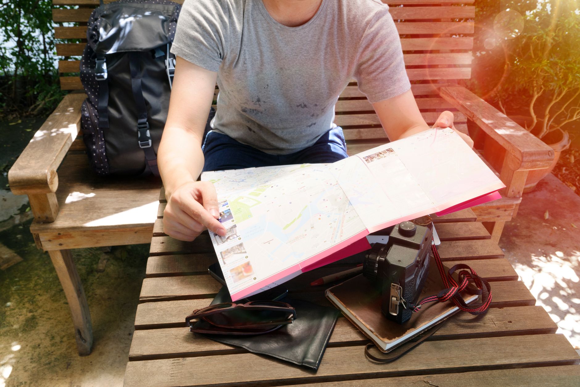 A traveler with a backpack reading a map