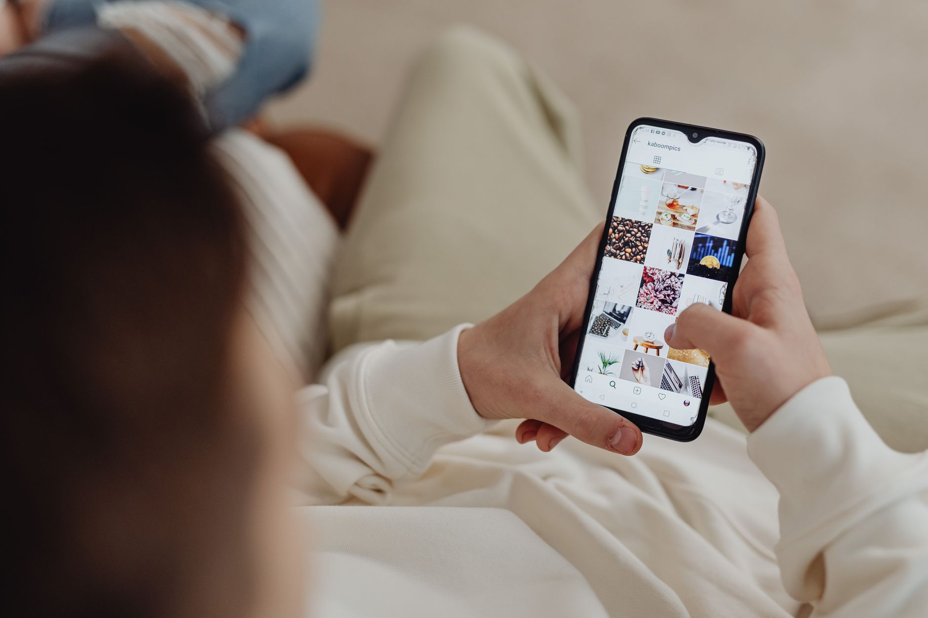 A person scrolling social media on a smartphone