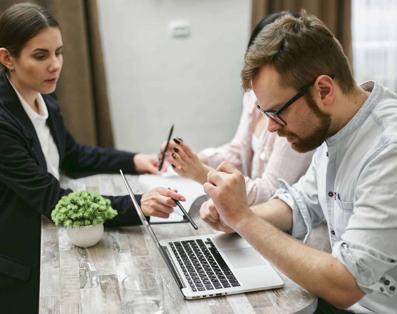 A small team meeting around a laptop
