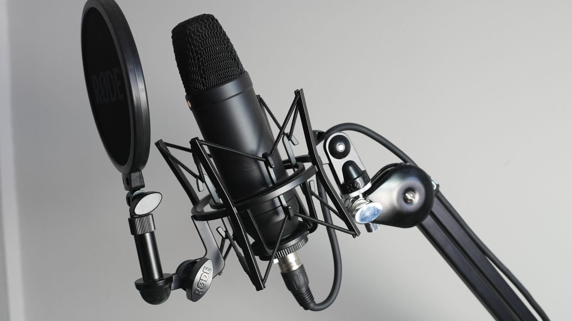 A home recording setup with a microphone and pop filter