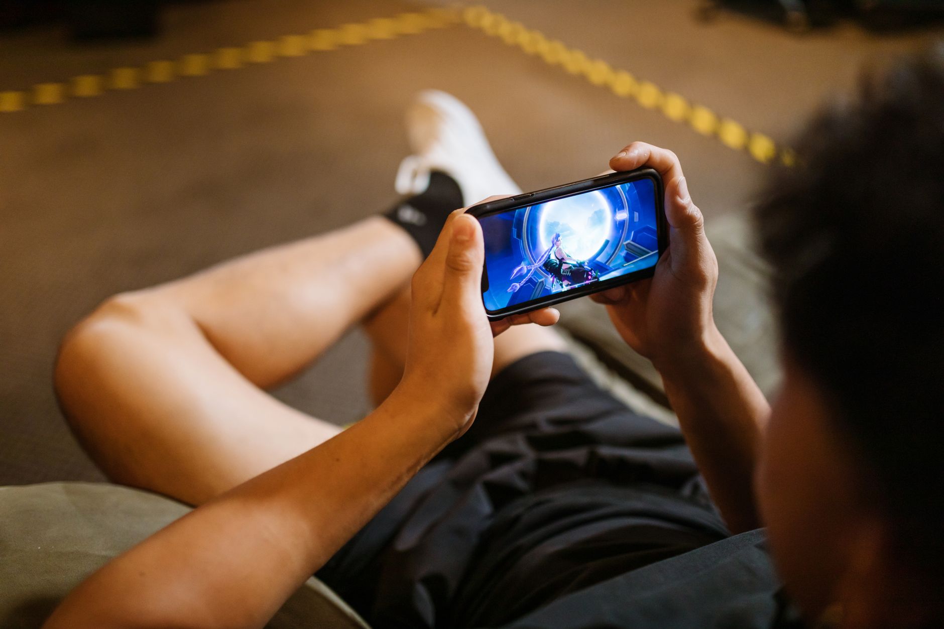 A person playing a game on a phone at night