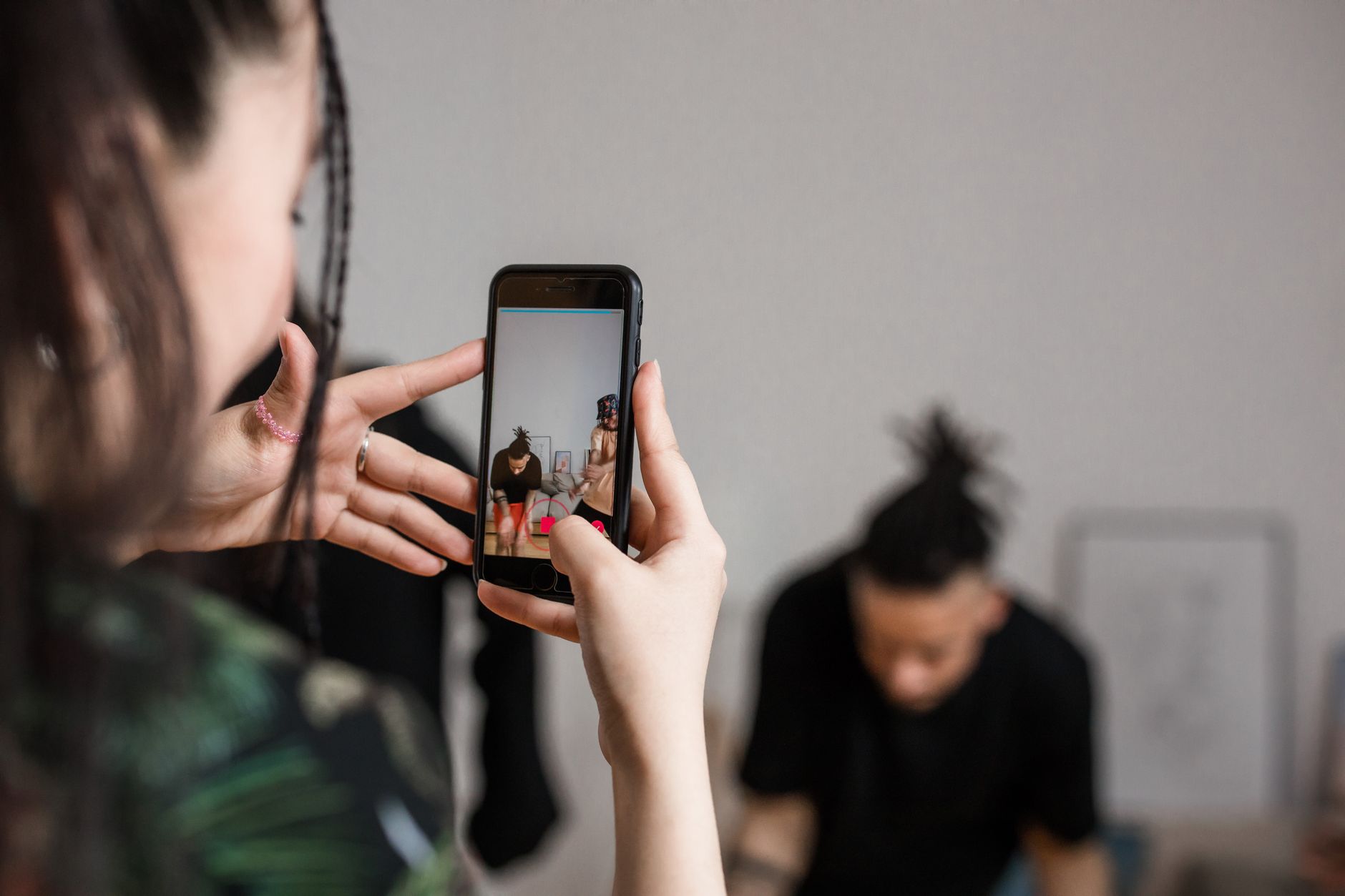 A person recording a video with a smartphone