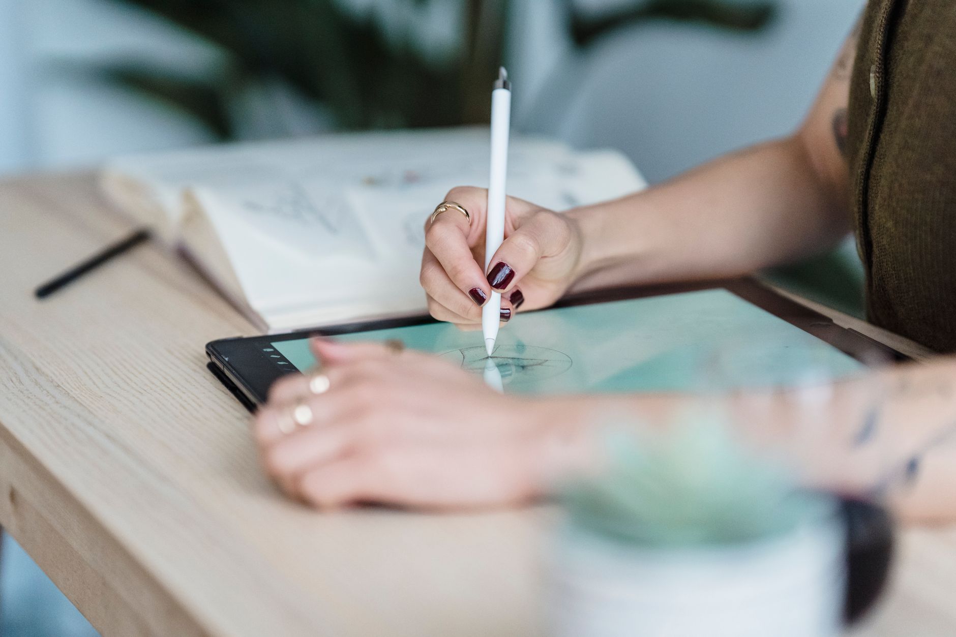 A designer sketching on a graphics tablet