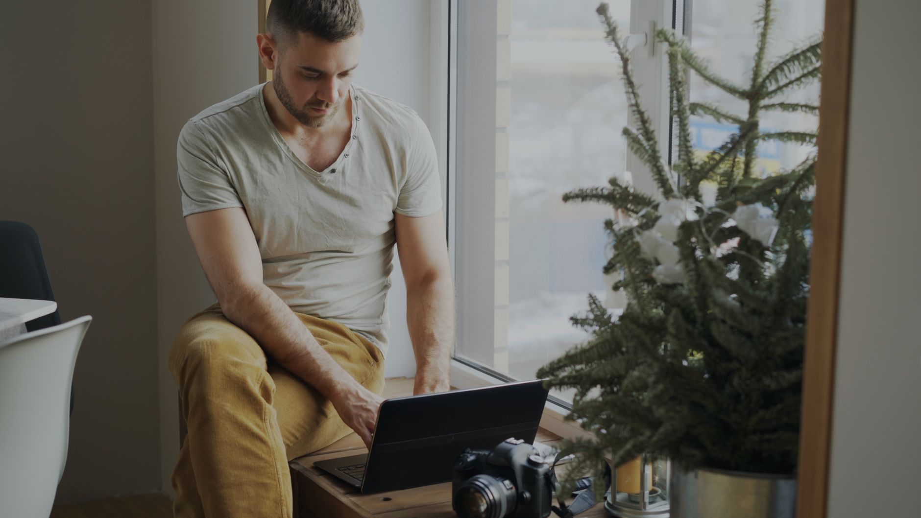 A man working on a laptop in his home office