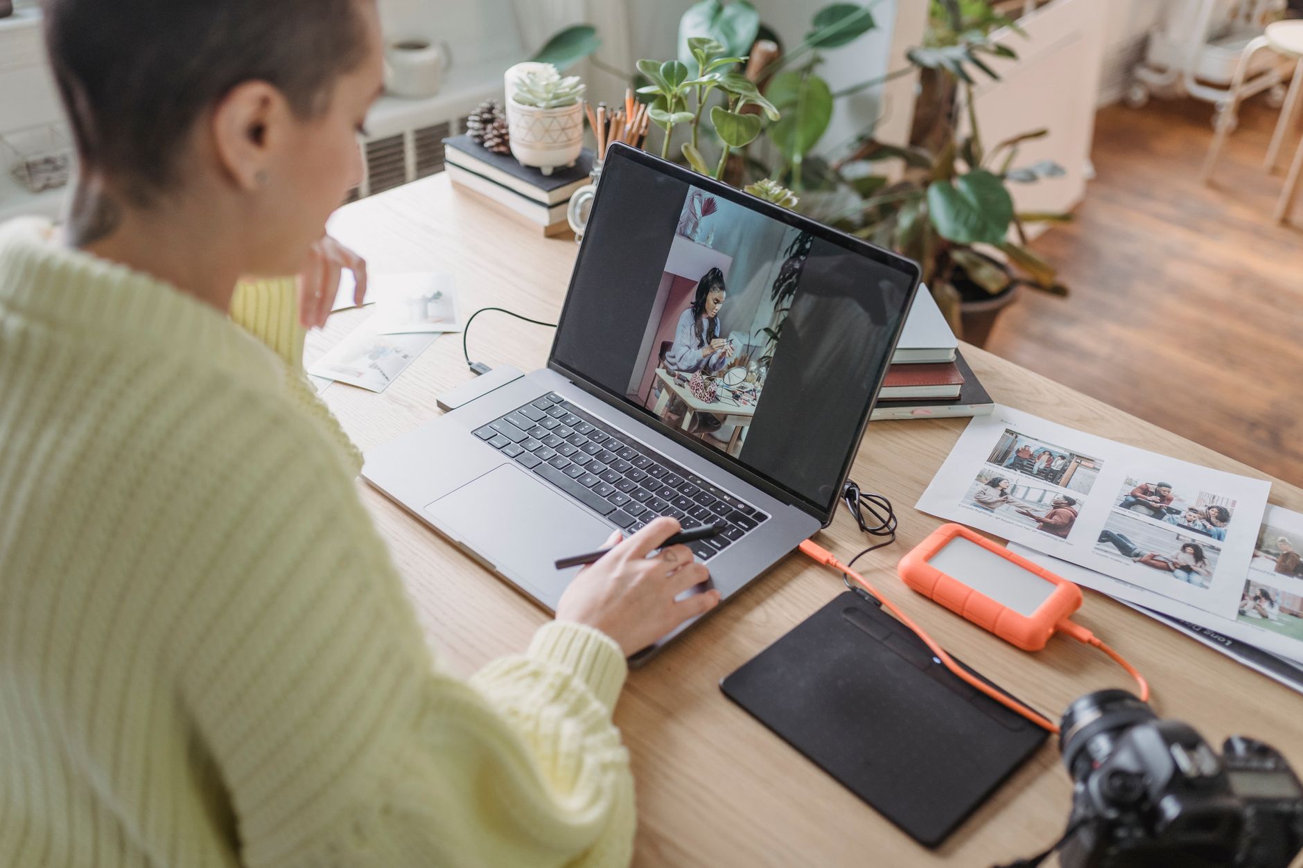 A photographer editing photos on a laptop