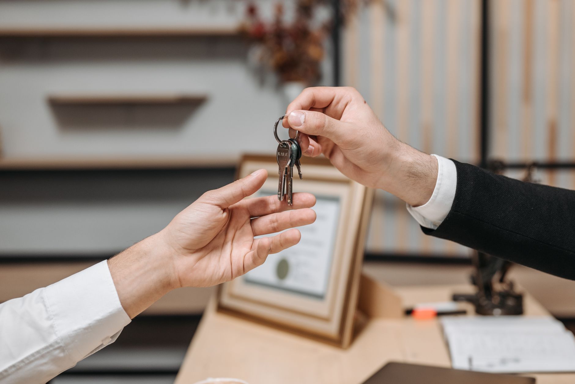 Keys being handed over at an apartment door